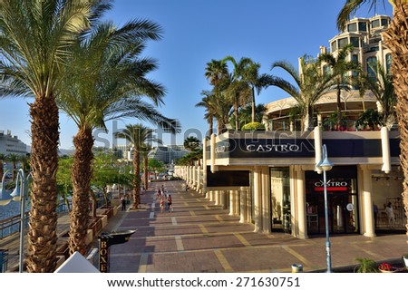 EILAT, ISRAEL - MARCH 31, 2015: Tourist walking on central street in Eilat at sunset time, famous international resort - the southest city of Israel
