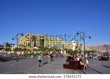EILAT, ISRAEL - MARCH 31, 2015: Tourist walking on central square in Eilat at sunset time, famous international resort - the southest city of Israel