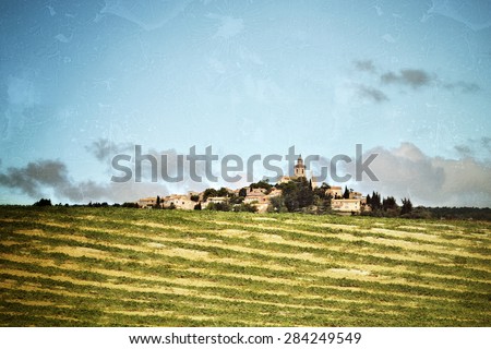 Provence landscape. Plateau de Valensole, Alpes-de-Haute-Provence, France. Rural field and medieval village on background. Filtered image, vintage effect applied