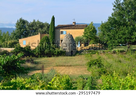 Typical old farmhouse and stone bories shown at sunset light. Provence, France.