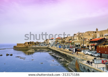ACRE, ISRAEL - MARCH 28, 2015: View at marina and old town of Acre at twilight time. Acre (Akko), one of the major tourist attraction of northern Israel