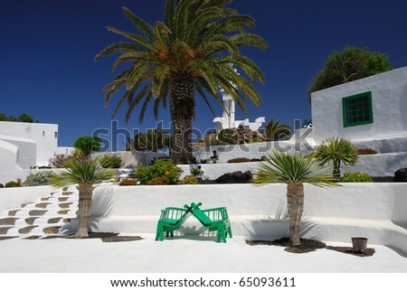 The courtyard in the spanish villa with green bench