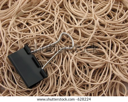 A pile of rubber bands and a single offset butterfly binder clip
