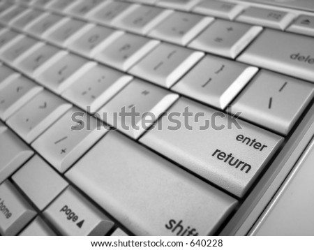 A close up of the Enter or Return button with other keys out of focus
