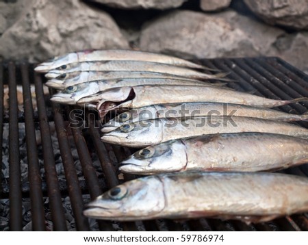 Image shows a mackarel fish on grill