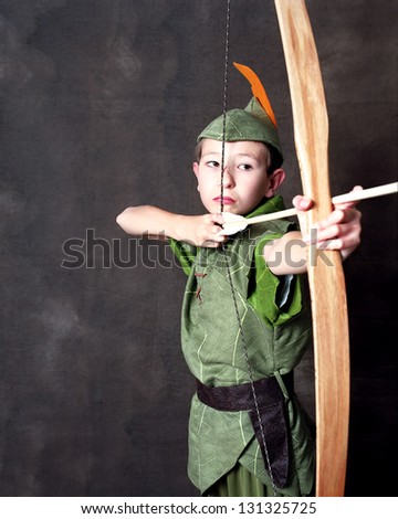 Young Robin Hood drawing a bow and arrow