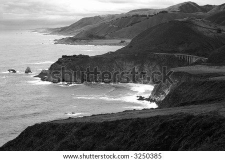 Black and white evening along ocean coast and bridge