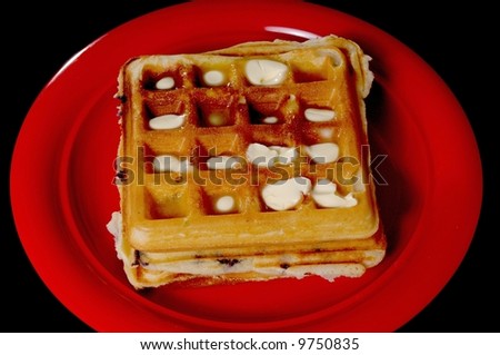 Blueberry waffles on plate isolated on black