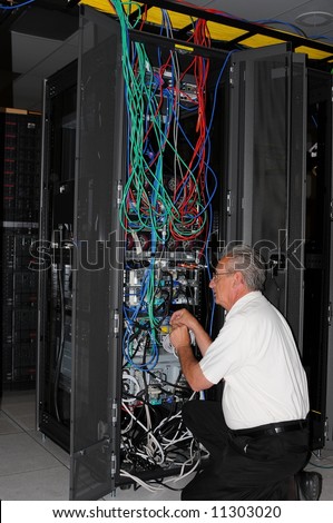 An engineer examining machine in computer room data center