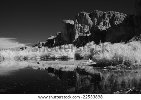 Black and white desert pond and mountains