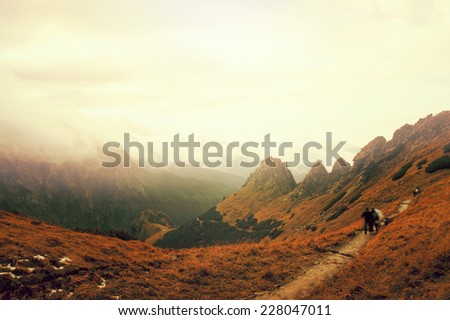 Tourists on the path in mountains, claming to the top of Giewont Mountain in Tatra Mountains., Poland.