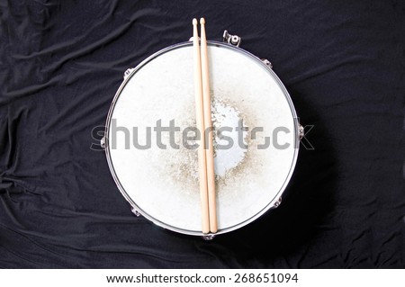 Drums conceptual image. Snare drum and stick over black background.