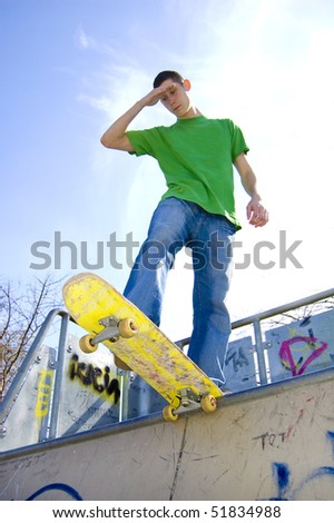 Sport conceptual image. Teenage skateboarder standing on the ramp.