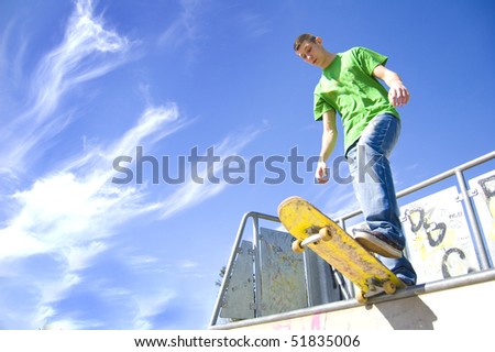 Sport conceptual image. Teenage skateboarder standing on the ramp with skateboard.