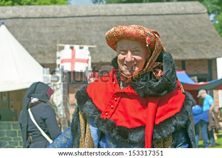 TATTON PARK, ENGLAND - JUNE 15: Jovial senior man in medieval costume, participant at The Medieval Fayre one of the most popular annual events of the Tatton Park in Cheshire, 15, June 2013.
