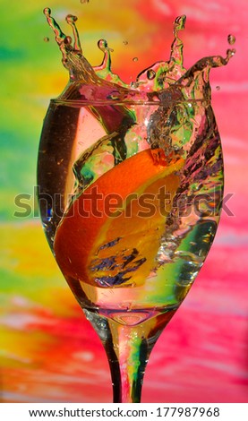 splash of drink with orange, colorful background