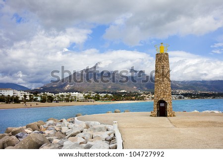 Stone lighthouse and pier in Puerto Banus near Marbella in Spain.