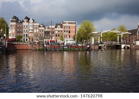 Amsterdam skyline, houses by the Amstel river and bridge on Nieuwe Herengracht, Netherlands, North Holland.