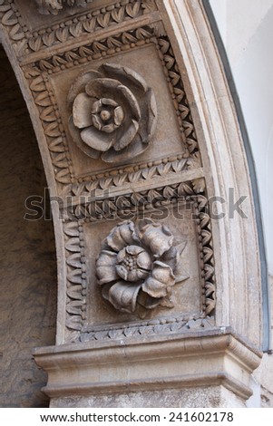 Flowers stone carvings on arch of the entrance gate to the Wawel Royal Castle in Krakow.