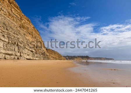 Similar – Image, Stock Photo Wide sandy Faro beach with dunes and walkways by the sunset, Algarve, Portugal