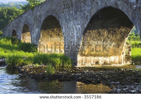 Ancient bridge in Ireland bathed in the sunset light.