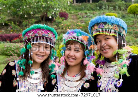 GOLDEN TRIANGLE REGION, THAILAND - OCTOBER 23: Young Hmong Hill Tribe girls in traditional costumes posing in village garden on October 23, 2007 in Golden Triangle Region, Thailand