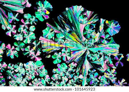 Colorful apearence of crystals of citric acid, a food additive, in polarized light.