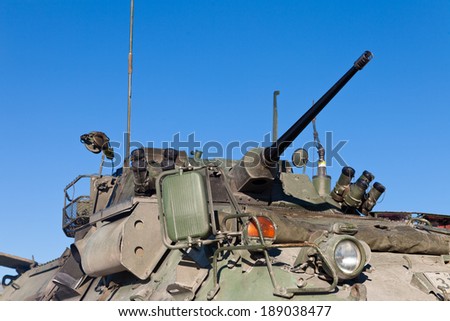 Close up view of the turret, armaments and gun of an operational military armored tank vehicle