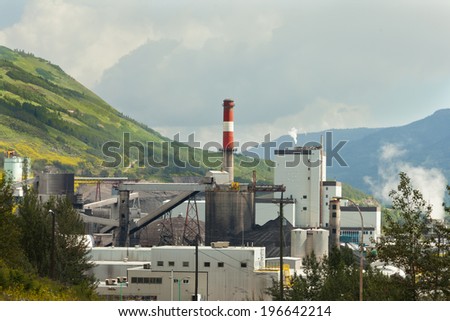 Black coal mine pile at coal fired electric energy power station in green valley contributes to global warming