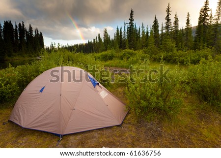Tent at the end of the rainbow on bank of Big Salmon River, Yukon T., Canada