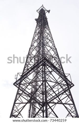 Metal tower with various communication antennas isolated on white.