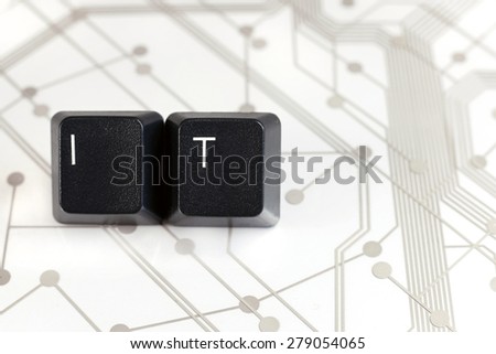 IT Helpdesk - Two Black Keyboard keys with letters I and T on White Circuit Board Background