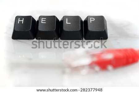 IT HELP - Four Black Keyboard Keys with Red Network Cable on White Glass Background