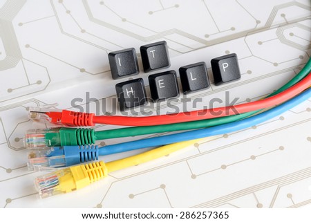 IT HELP, Assistance - Word IT HELP made of keyboard keys with colourful network cables on white circuit board background