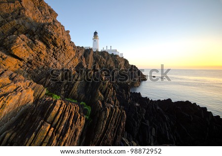 Sunrise at Douglas Lighthouse with Cliffs on the Isle of Man
