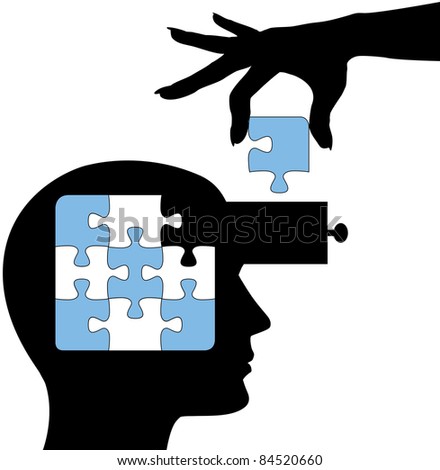 Hand puts the solution to a puzzle into the mind of a learning person