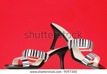Black and white high heels or pumps on a red background