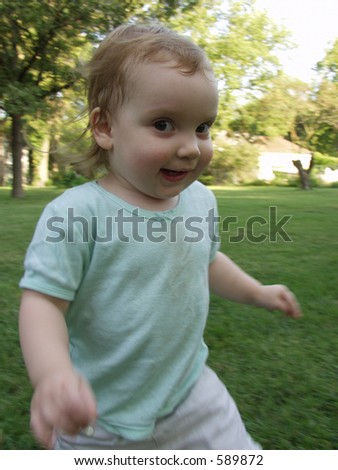 running happy toddler playing at park