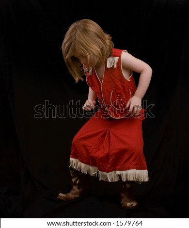 Little girl in a vintage cowgirl outfit.