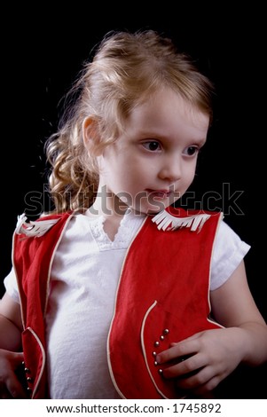 Little girl in a bright red cowgirl outfit.
