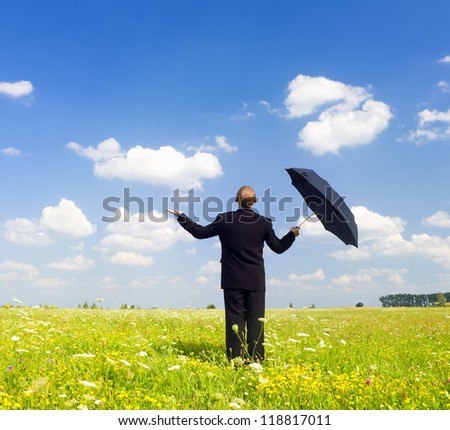 The person with an umbrella in the field