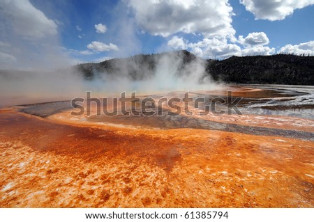 orange crust surrounds one of Yellowstone's  smoldering springs