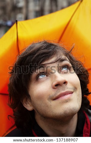 Attractive Smiling Man with Umbrella Checking Sky After Rain