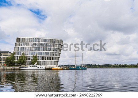 Similar – Image, Stock Photo View over the Warnow river to the city of Rostock in the evening