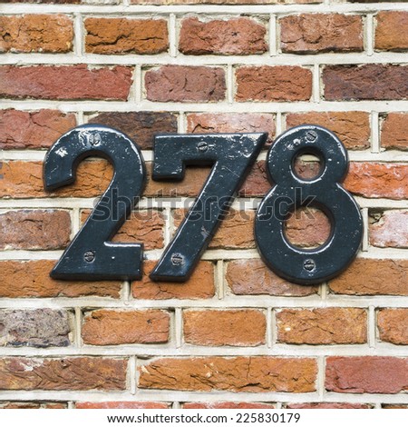 house number two hundred and seventy eight. Separate lettering on a red brick wall.