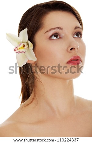 Isolated on the white background. Beautiful naked woman with orchid flower in hair.