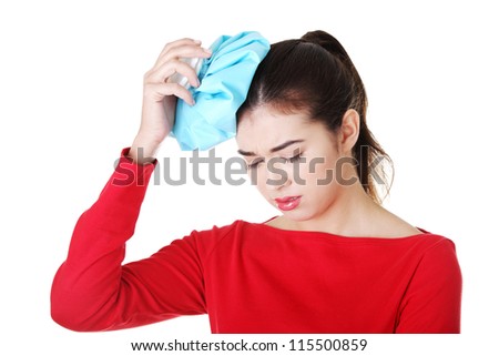 Woman with ice bag for headaches and migraines , isolated