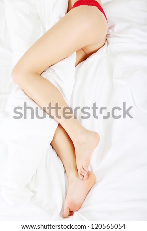 Woman legs on the bed