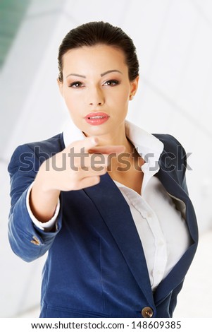 Young beautiful caucasian business woman pointing on you