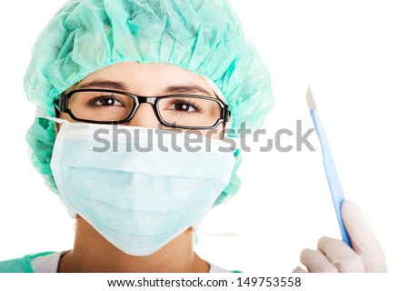 Portrait of happy young woman doctor or nurse with surgical mask and cap